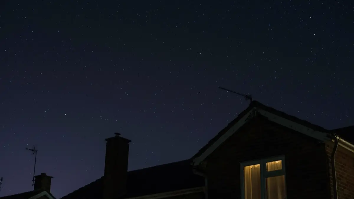 Home exterior at night under a starry sky