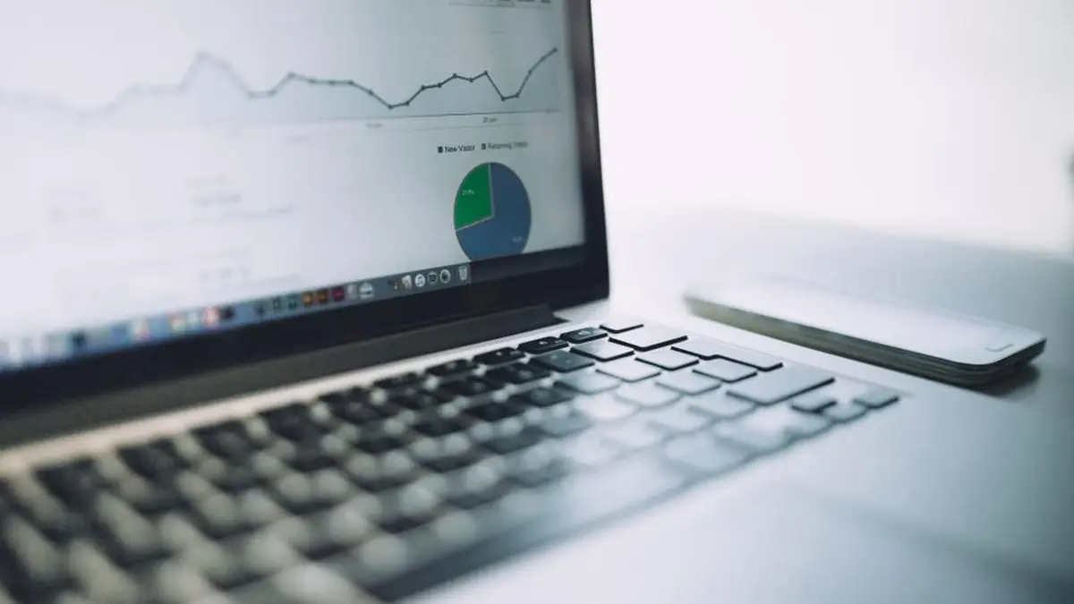 Laptop screen showing analytics charts and website traffic data