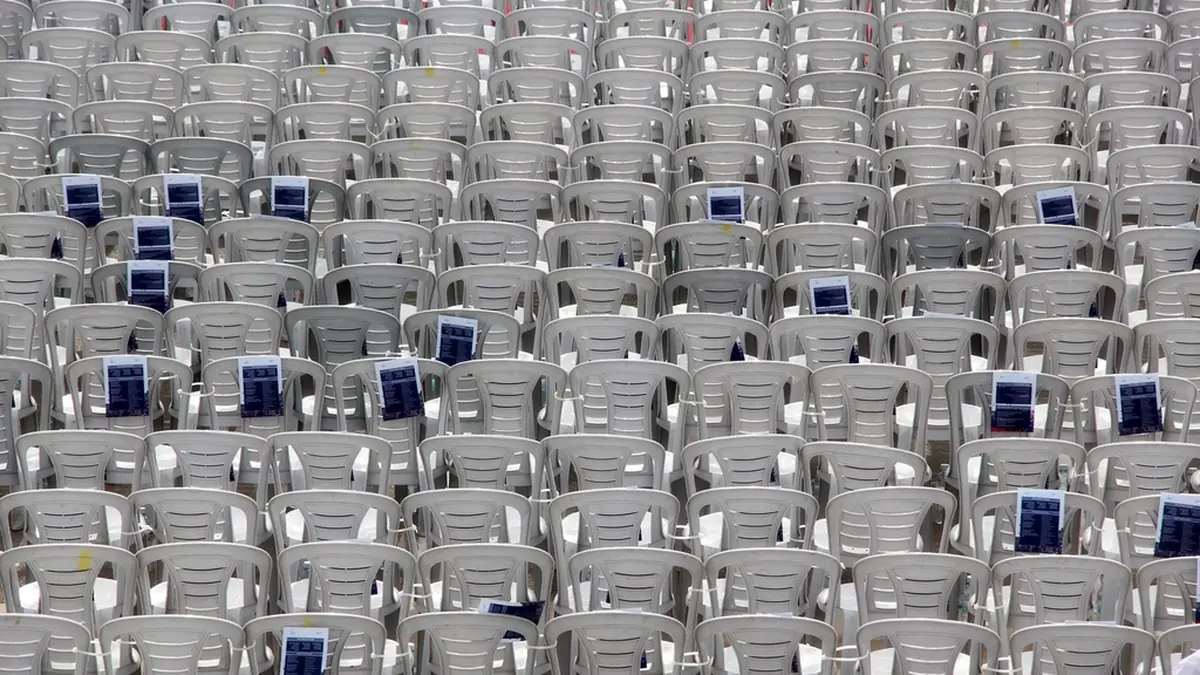 Rows of empty white chairs, the cost of missed appointments