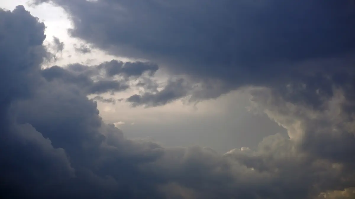 Dramatic storm clouds with sun rays breaking through